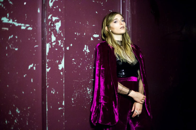 Verite wears the Magenta velvet suit while on tour